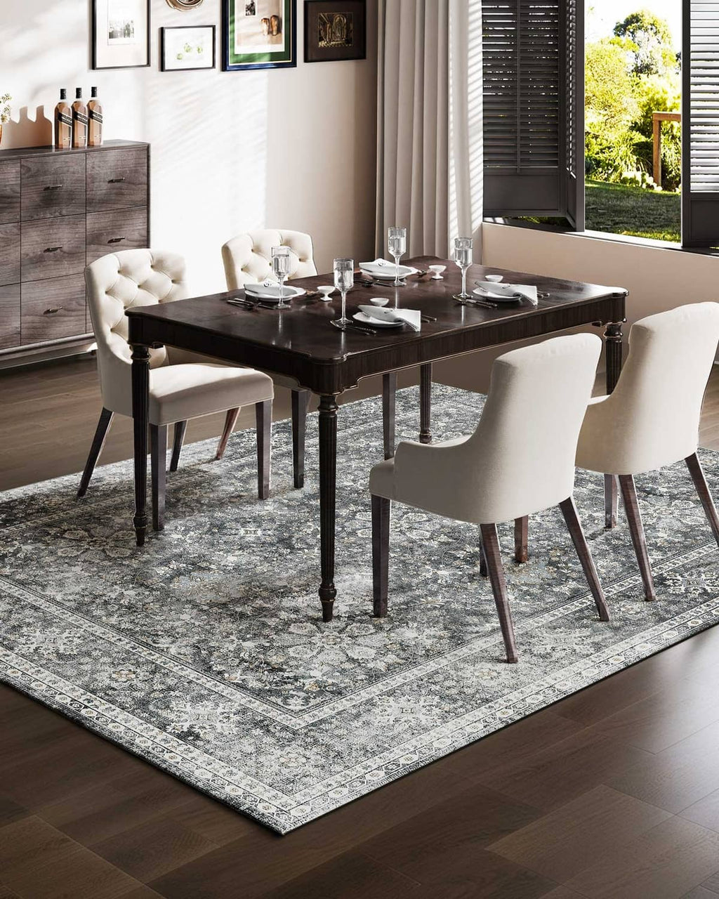 Gray vintage area rug with distressed floral medallion pattern and decorative border