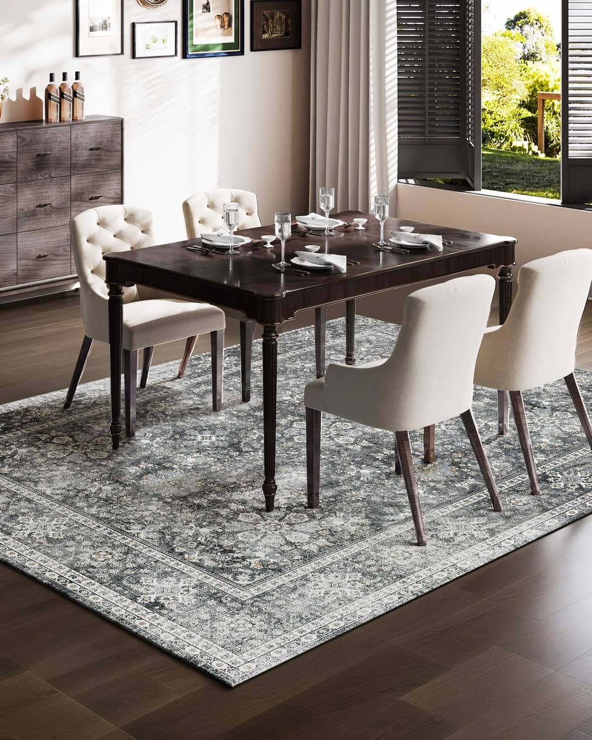Gray vintage area rug with distressed floral medallion pattern and decorative border