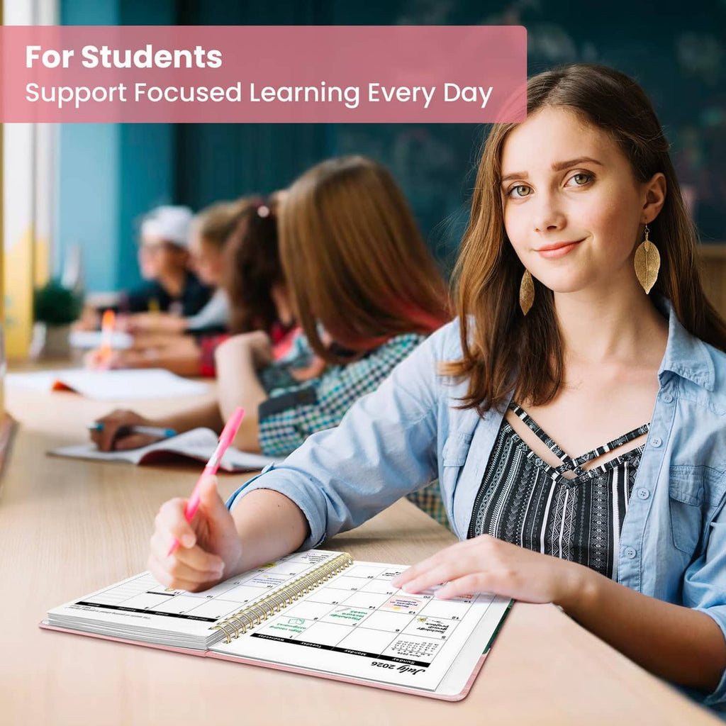 Student writing in an open planner with monthly calendar layout visible