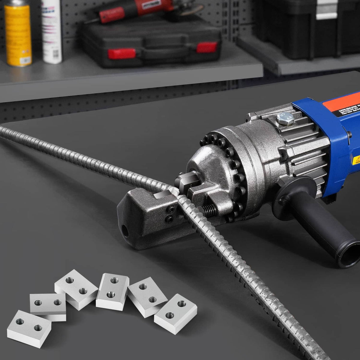 Rebar cutter blades on a metal base, shown near a blue rebar cutting tool.