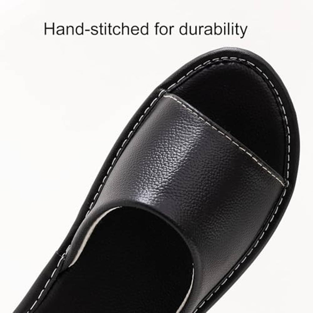 Black leather slide sandal upper with visible white stitching and open toe.