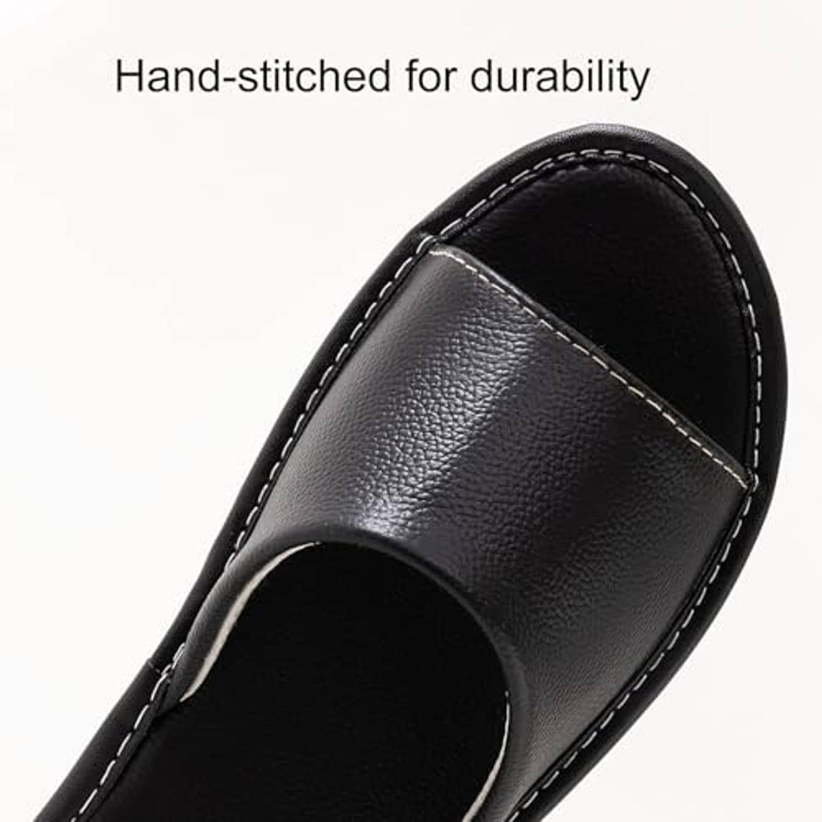 Black leather slide sandal upper with visible white stitching and open toe.