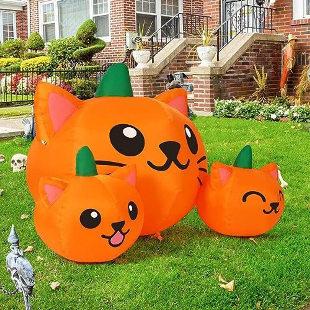 Orange inflatable cat-head trio with green cone hats for outdoor yard decoration