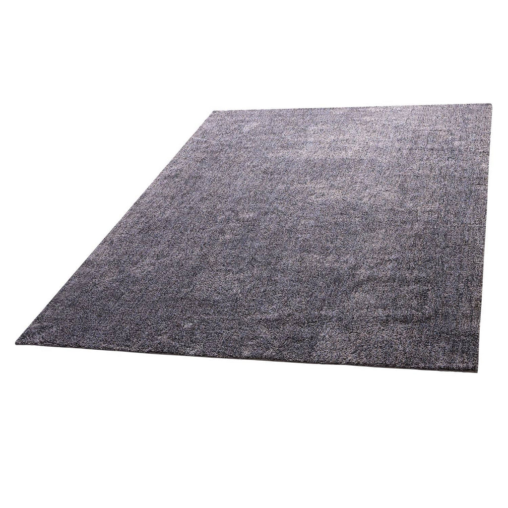 Dark gray plush indoor area rug, close angled view, speckled low-pile texture