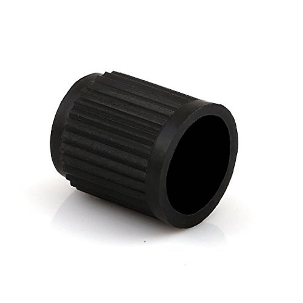 Black ribbed plastic valve stem cap with open end, close-up