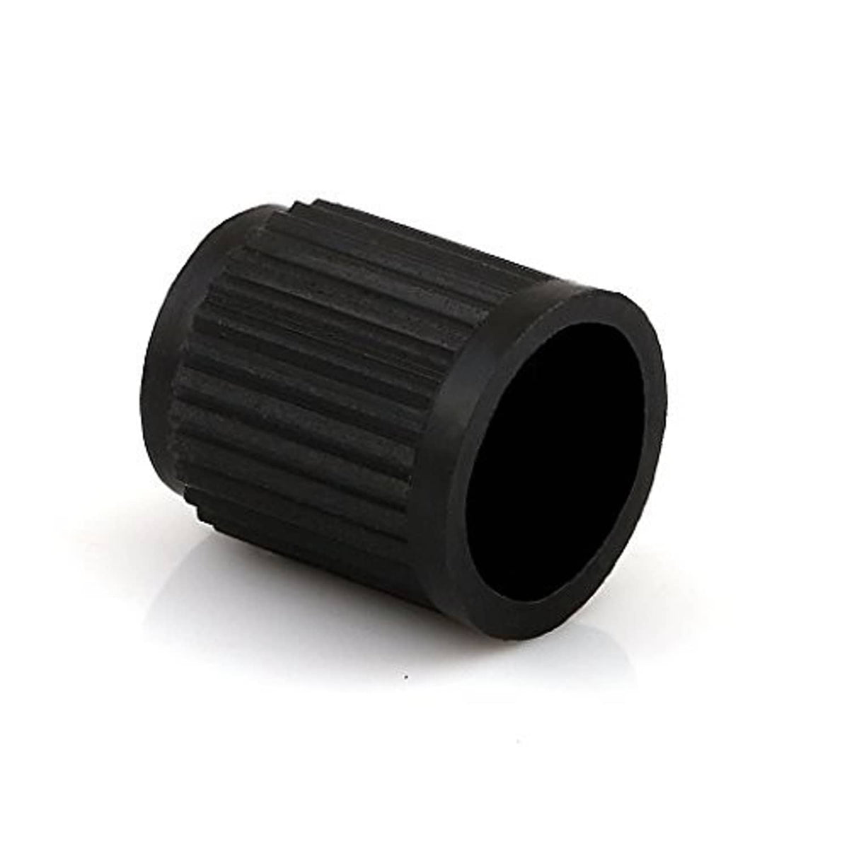 Black ribbed plastic valve stem cap with open end, close-up