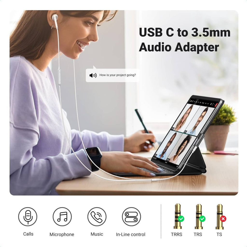 Black USB-C to 3.5mm audio adapter connected to a device with headphone cable