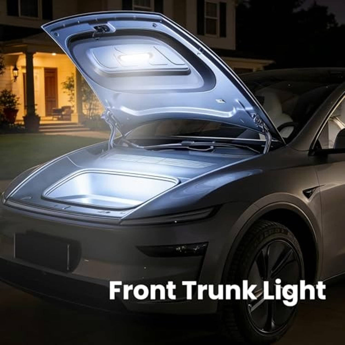 Front trunk light illuminating items with hood open on a car at night
