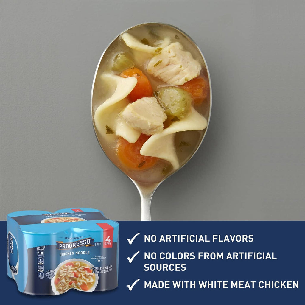 Spoonful of chicken noodle soup with chicken, noodles, and carrots