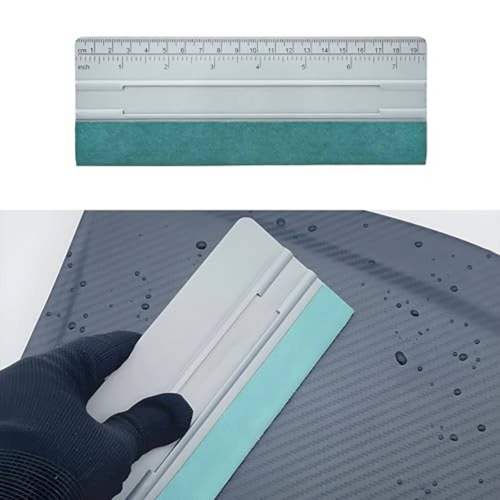 Felt squeegee applicator with teal felt pad being pressed on a vinyl film surface