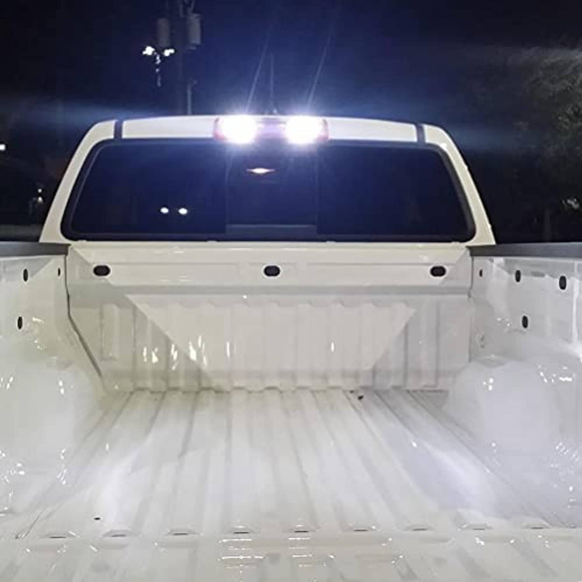 Illuminated LED third brake light above truck cab, bright white light bar