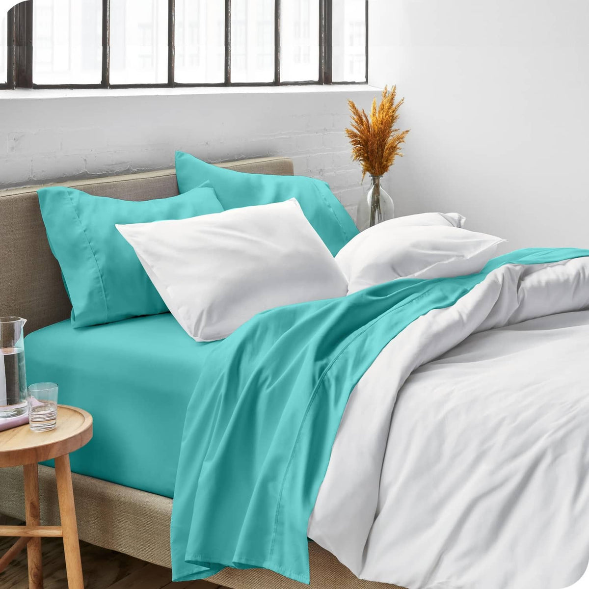Turquoise twin bed sheet set with top sheet and matching pillowcases on bed