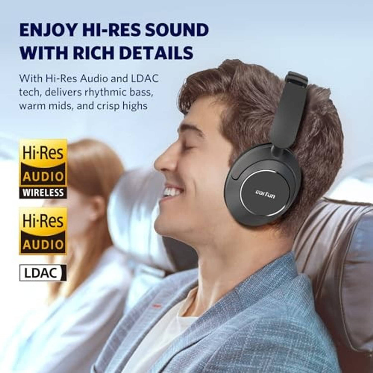 Black over-ear headphones worn on a person, showing padded earcups and headband