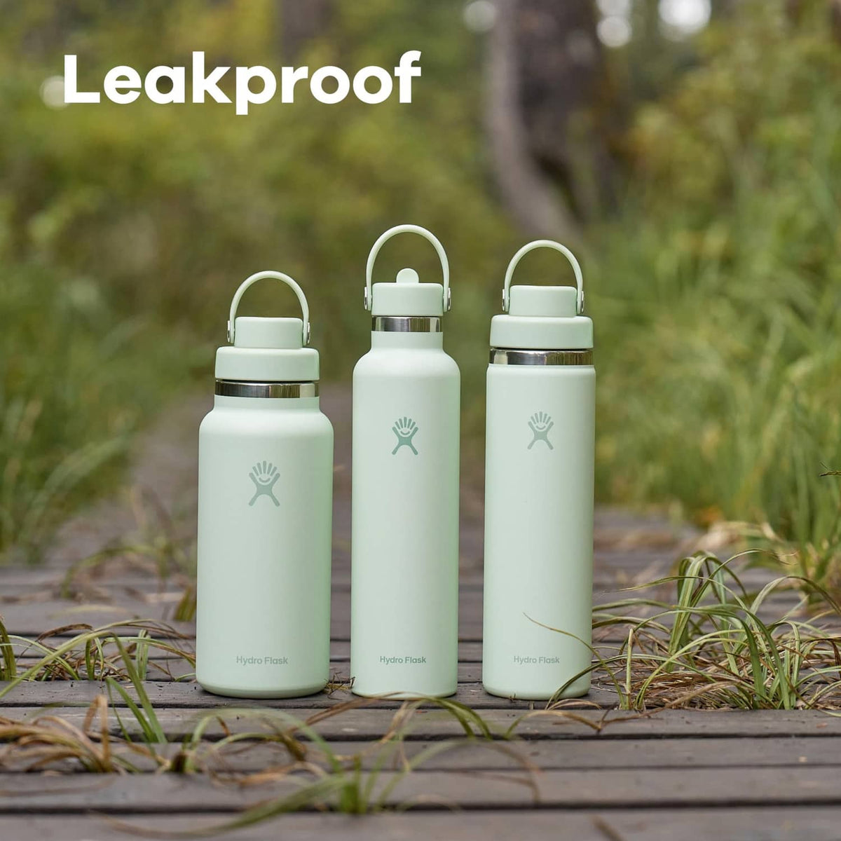 Set of three insulated stainless steel water bottles with matching caps and carry handles.