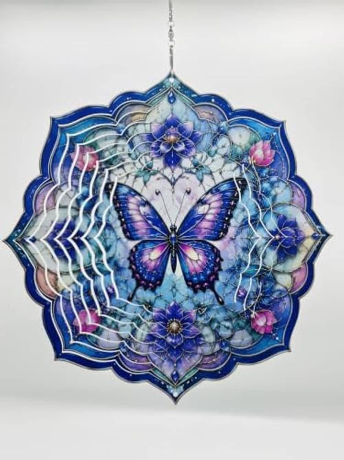 Blue and purple hanging wind spinner featuring butterfly centerpiece and floral filigree