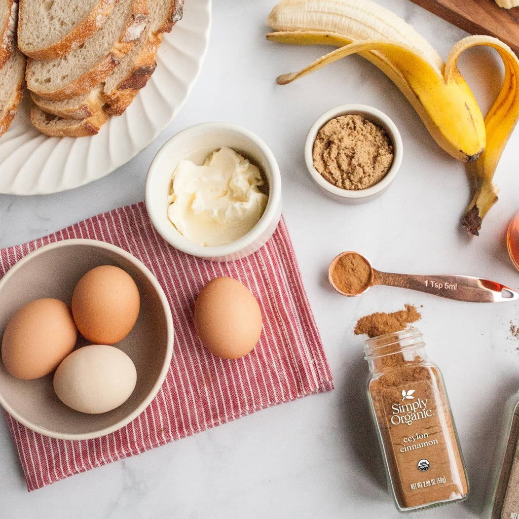 Ceylon cinnamon spice bottle with eggs, bread, banana, and small bowls of cinnamon