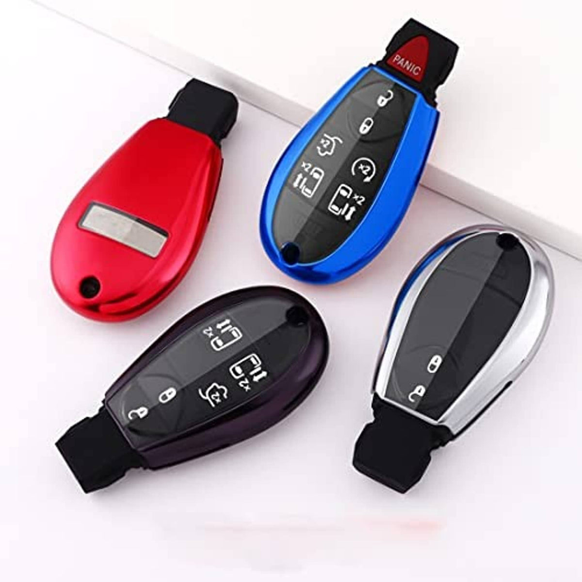 Set of smart remote key fob cover cases: red, blue, black, and silver with keyring loops
