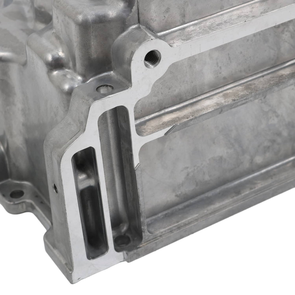 Engine oil pan kit casting with mounting bracket, bolt bosses, and an open channel