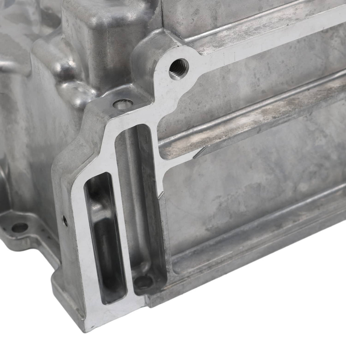 Engine oil pan kit casting with mounting bracket, bolt bosses, and an open channel