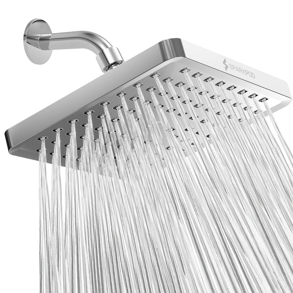 Square polished chrome rain shower head angled with water falling from nozzles