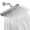 Square polished chrome rain shower head angled with water falling from nozzles