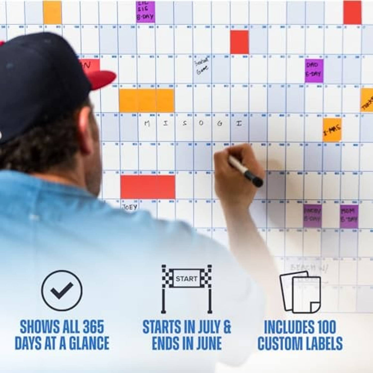 Dry-erase wall calendar grid with colored boxes, marker writing on the date squares