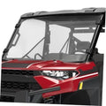 Polaris front windshield with clear panel and black frame, mounted on corner brackets
