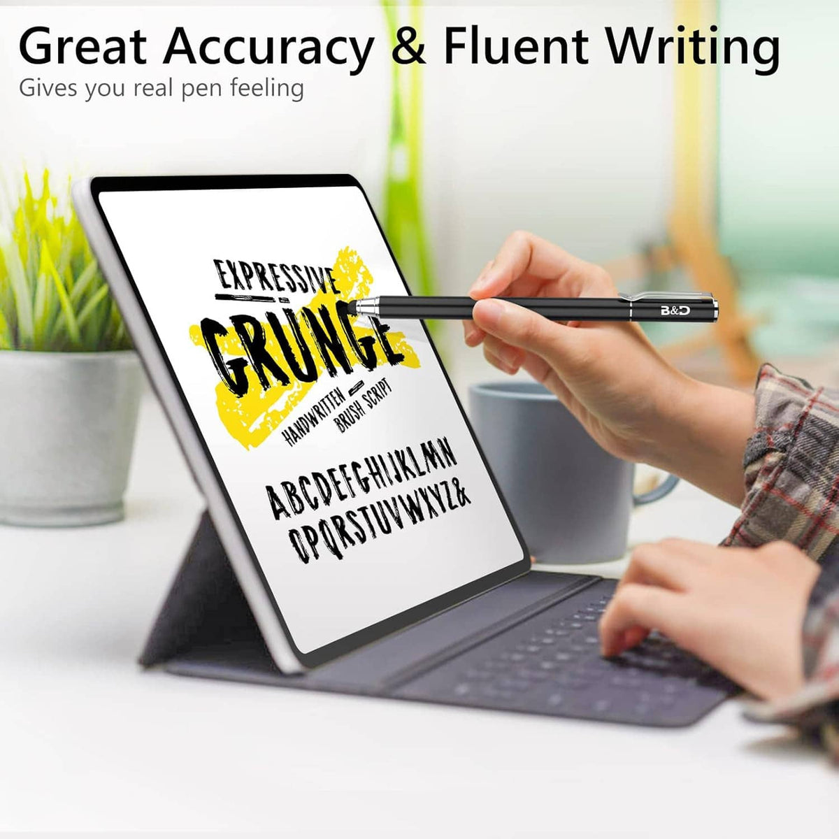 Black touch screen stylus pen held in hand writing on a tablet