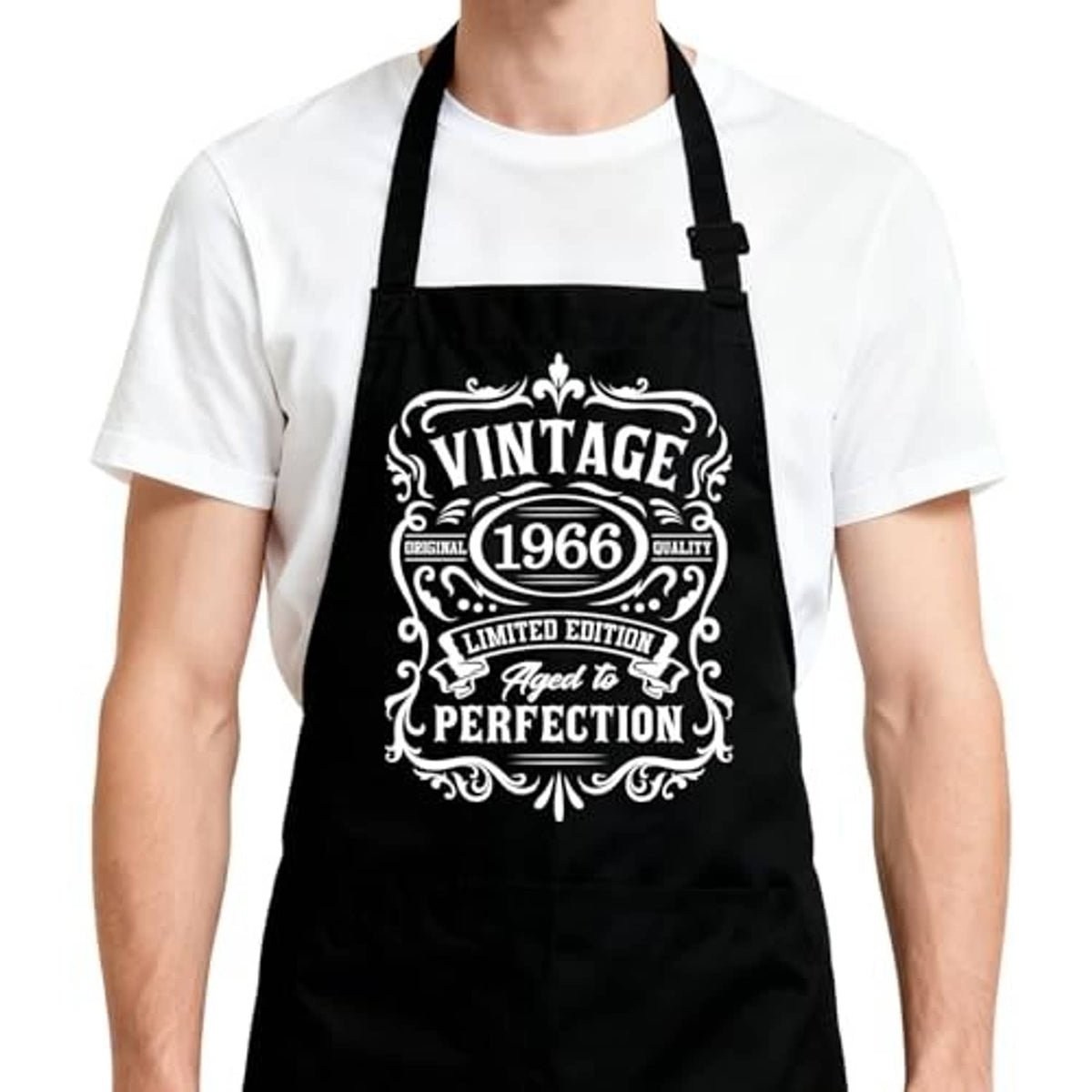 Black kitchen apron with adjustable straps and central vintage 1966 style emblem.