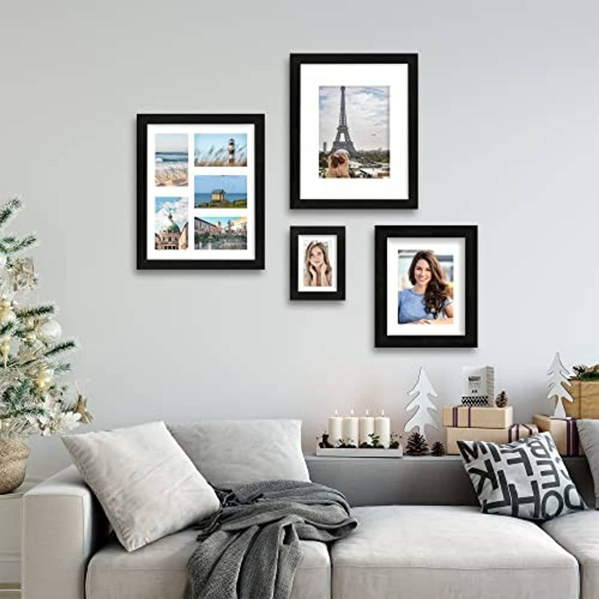 Cluster of rustic black 11x14 picture frames on a wall above a sofa.