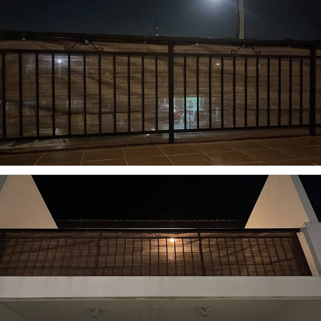 Coffee-brown balcony privacy screen cloth on railing at night, partial visibility