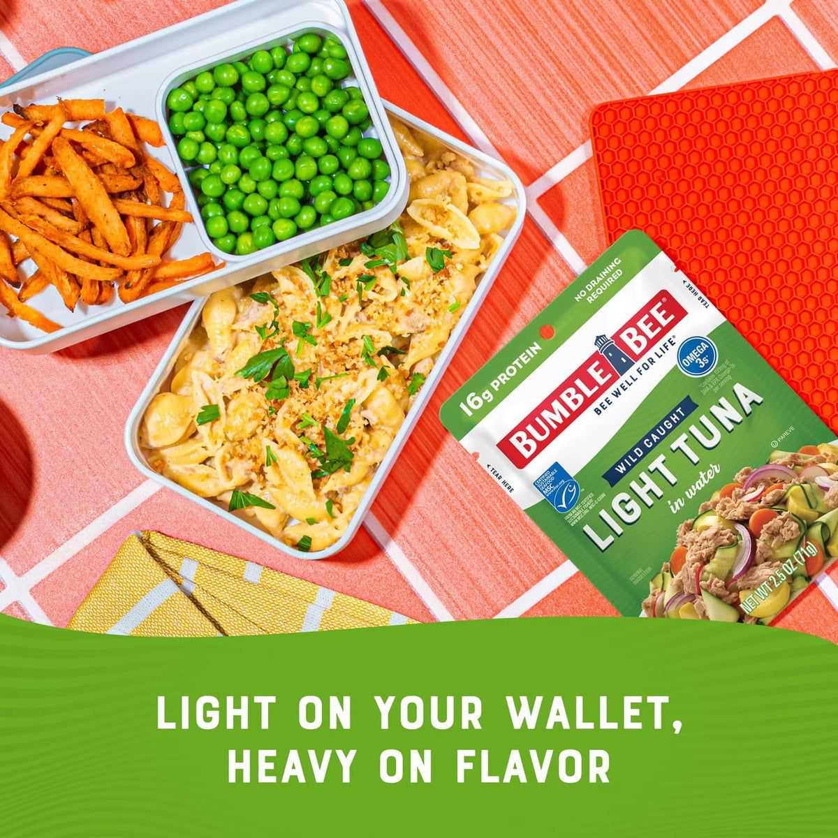 Light tuna pouch next to prepared meal containers with peas and carrots