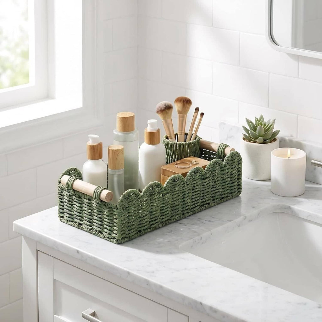 Green woven scalloped bathroom storage basket with wood handles, holding toiletries