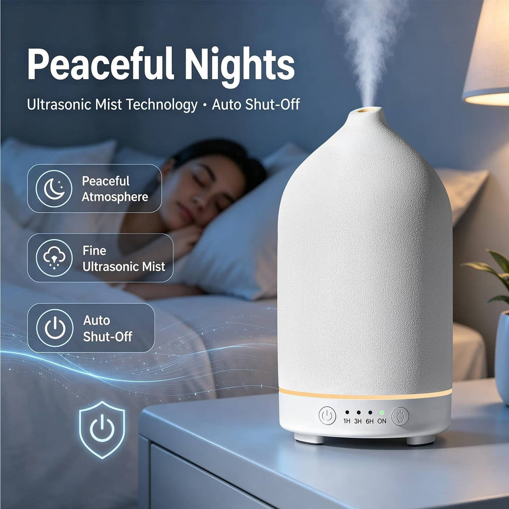 White ceramic essential oil diffuser with warm amber LED glow and mist for nighttime.