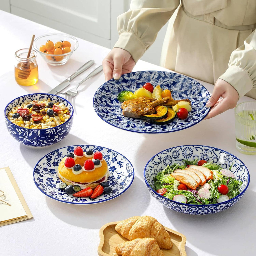Blue-and-white patterned plates and bowls for serving, held by a person