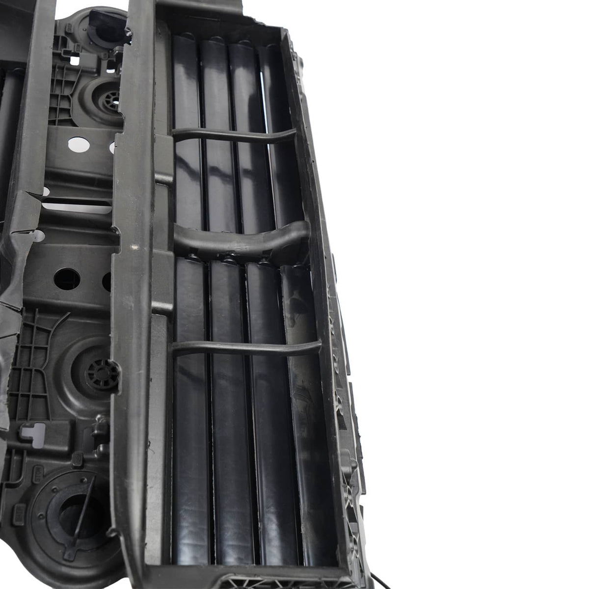Close-up of inner black grille shutter slats with metal linkage bar
