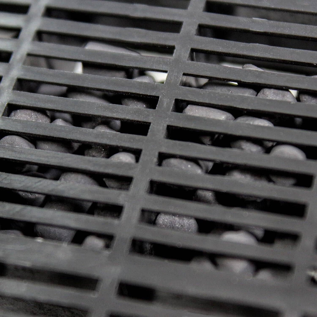 Black plastic filter grid with square openings for water circulation