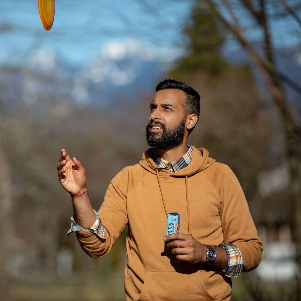 CLIF BAR Minis energy bar pack held outdoors with 110 calories