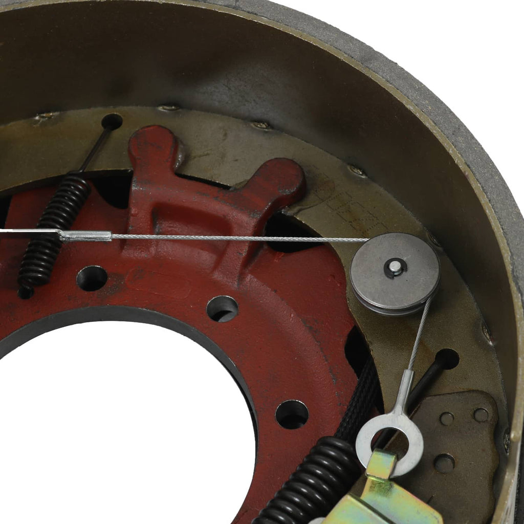 Electric trailer brake backing plate assembly close-up of red brake arm and springs