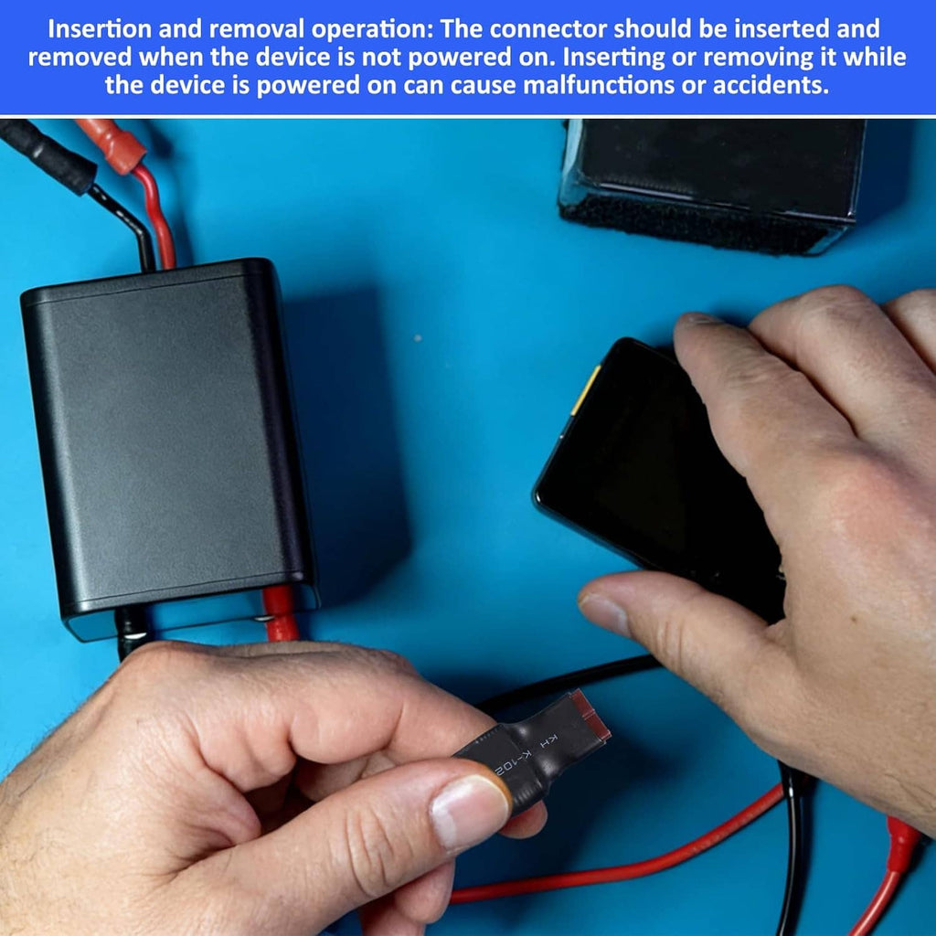 Hands inserting a connector plug; EC5 to T-plug adapter with black housing and blue sleeves