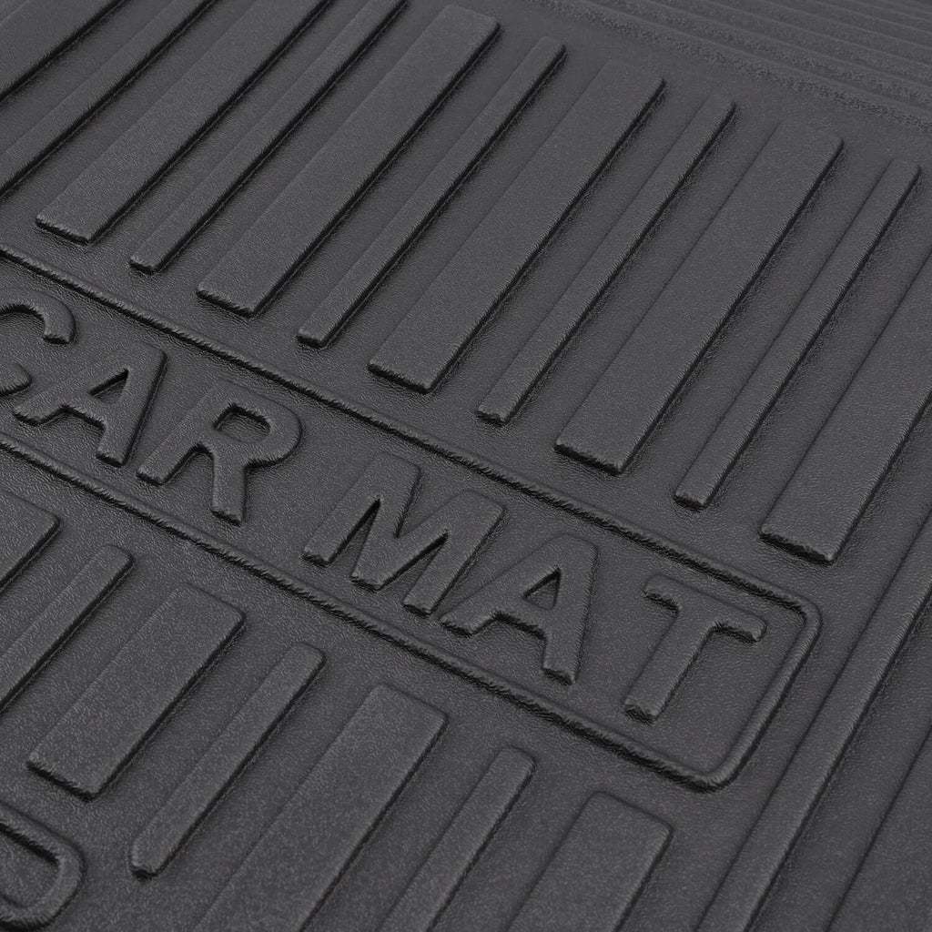 Close-up of black rubber floor mat surface with embossed wording and ribbed pattern