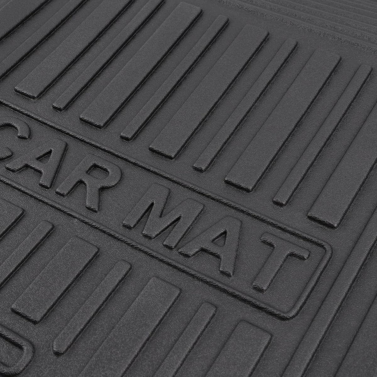 Close-up of black rubber floor mat surface with embossed wording and ribbed pattern