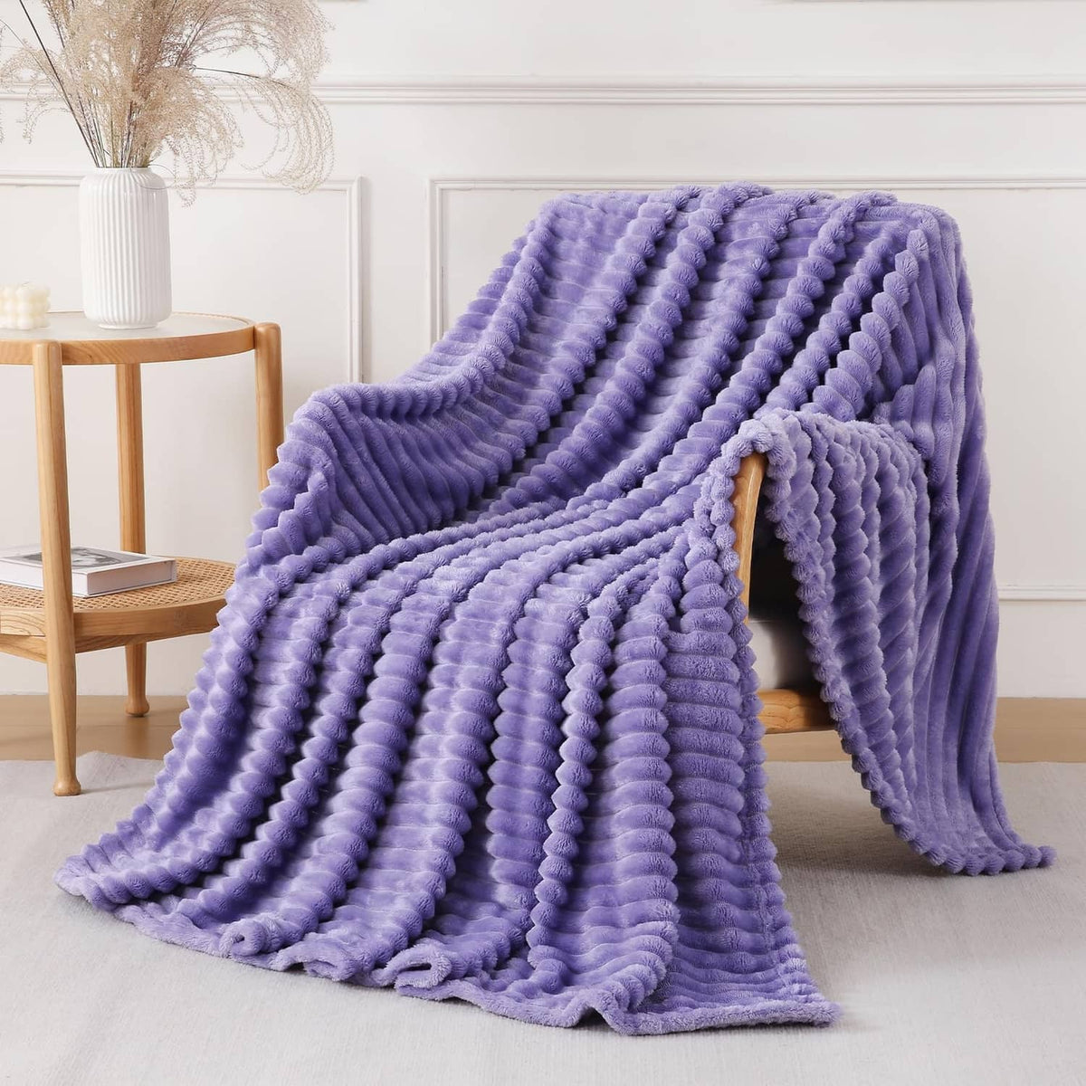 Lavender plush knit throw blanket with chunky looped texture, draped on couch