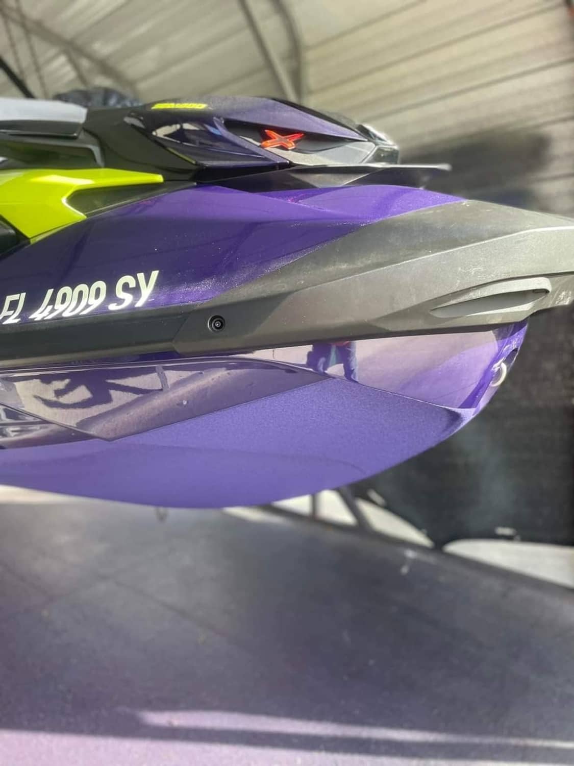 Purple jet ski side panel close-up with textured hull surface