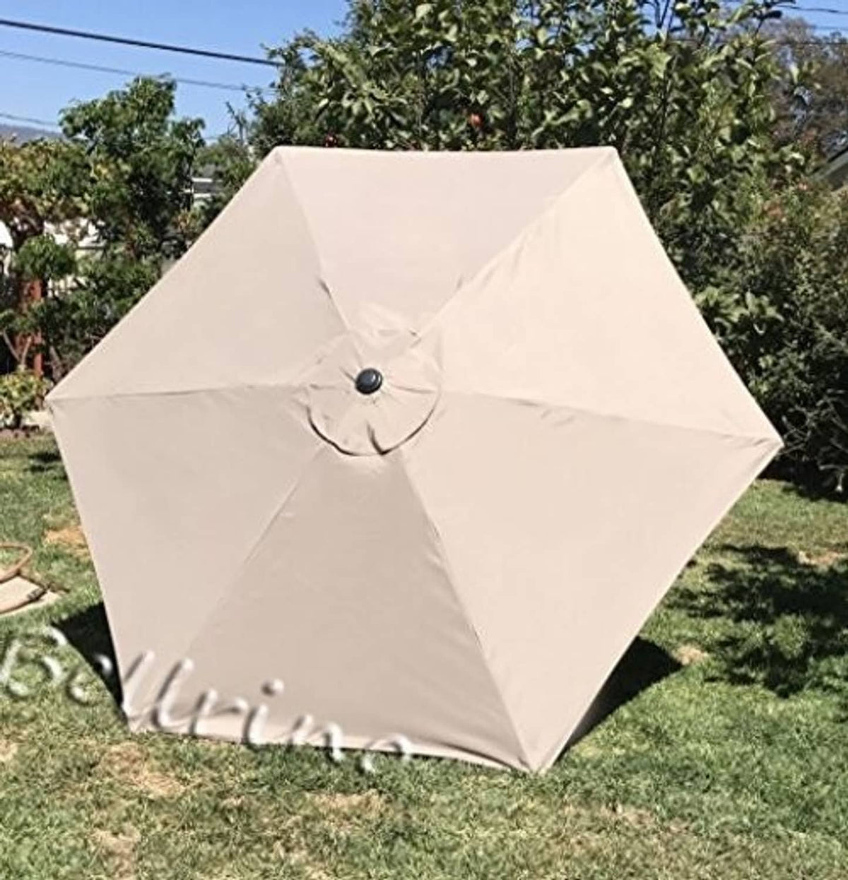 Off-white patio umbrella canopy with central button and folded seam details
