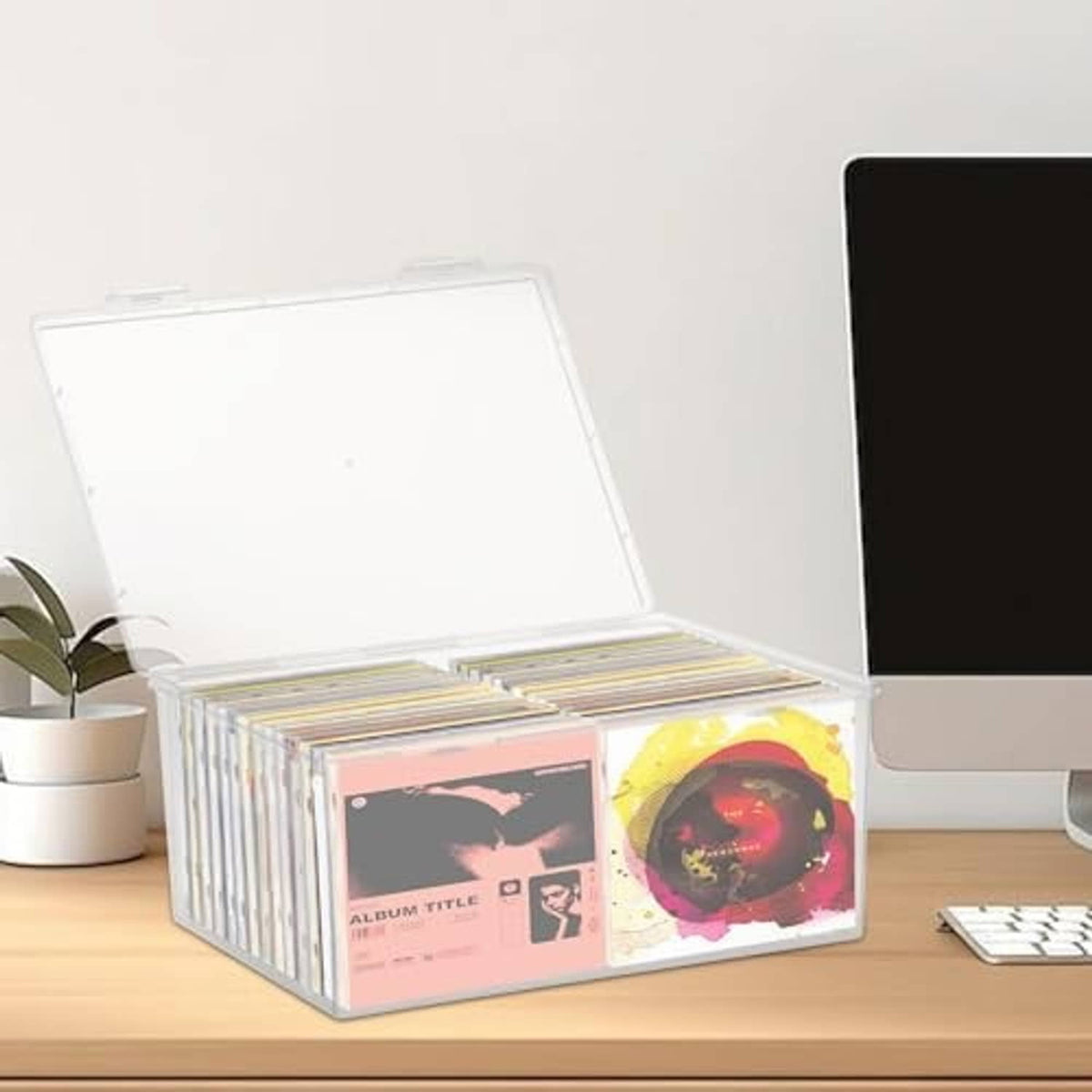 Clear CD organizer box with hinged lid, stacked CDs visible through the plastic