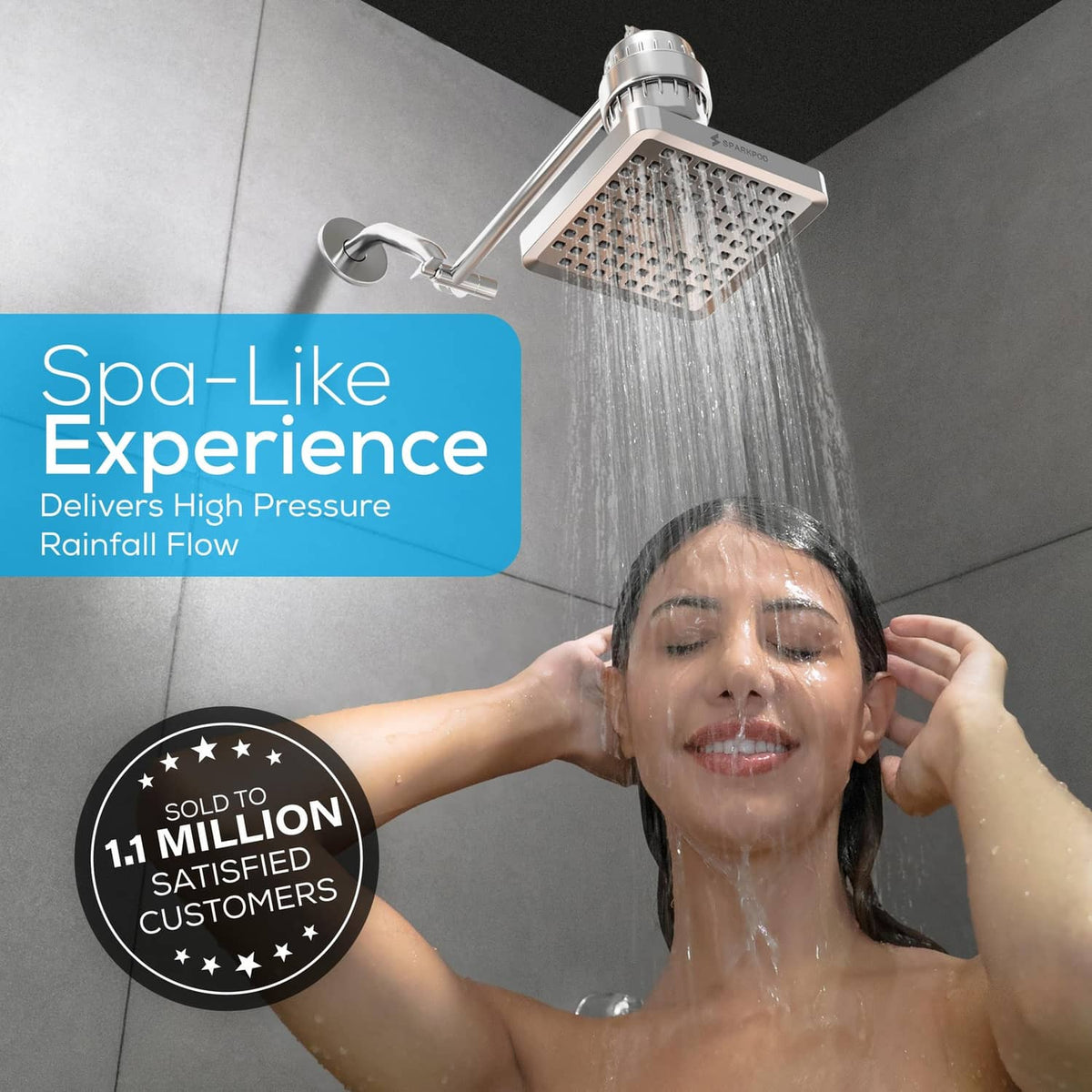 Polished chrome square rain shower head spraying water from multiple nozzles