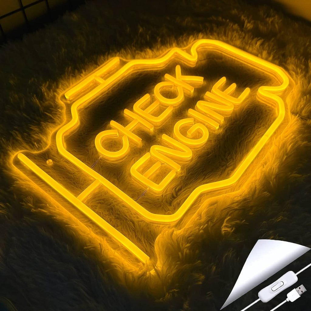 Yellow glowing 'CHECK ENGINE' neon sign on plush surface, engine-outline frame.