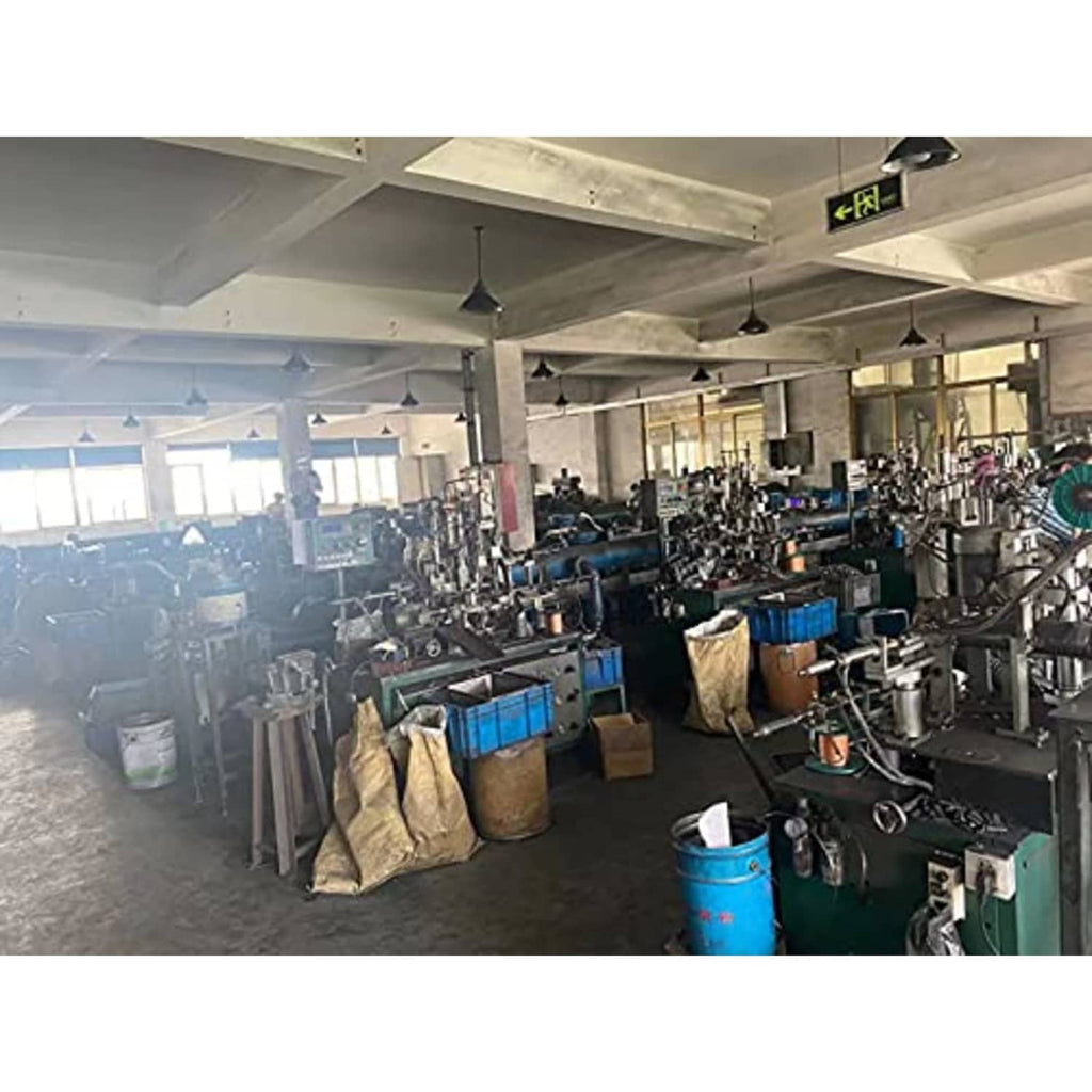 Industrial workshop with rows of workbenches, metal tools, and power machines
