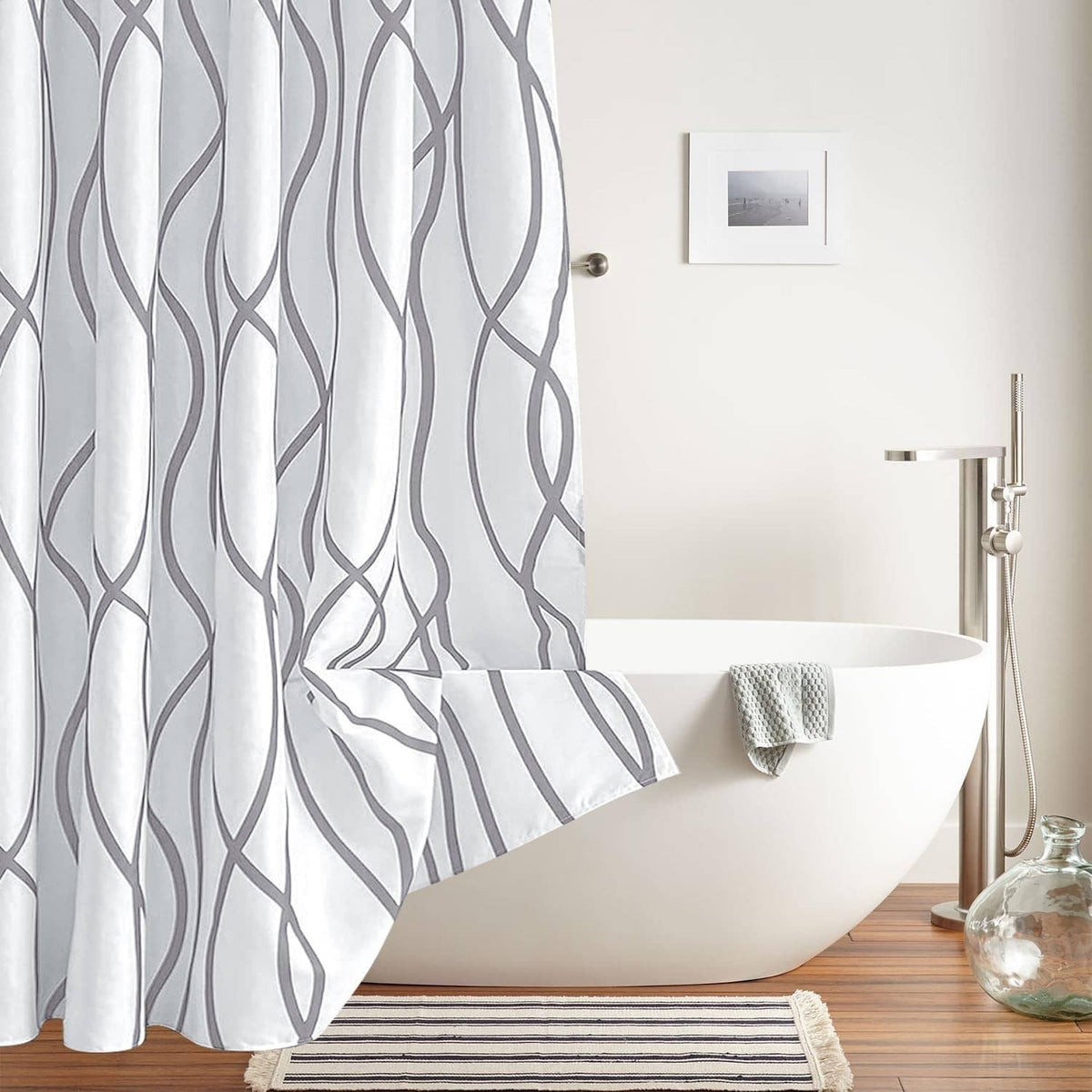 Silver gray shower curtain with repeating wavy line pattern and pleated fold at bottom